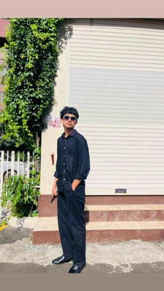 Aflah - Freelance Digital Marketer in Kannur standing outdoors in a stylish dark outfit